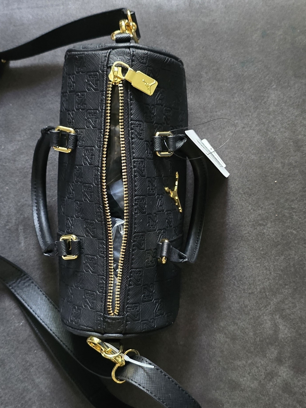 A black Jordan Monogram Mini Duffle Bag With Jump Man On It - Picture 6 of 10